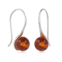 Boucles d'oreilles pendantes en argent 925/000 rhodié surmontées d'une véritable perle d'ambre.